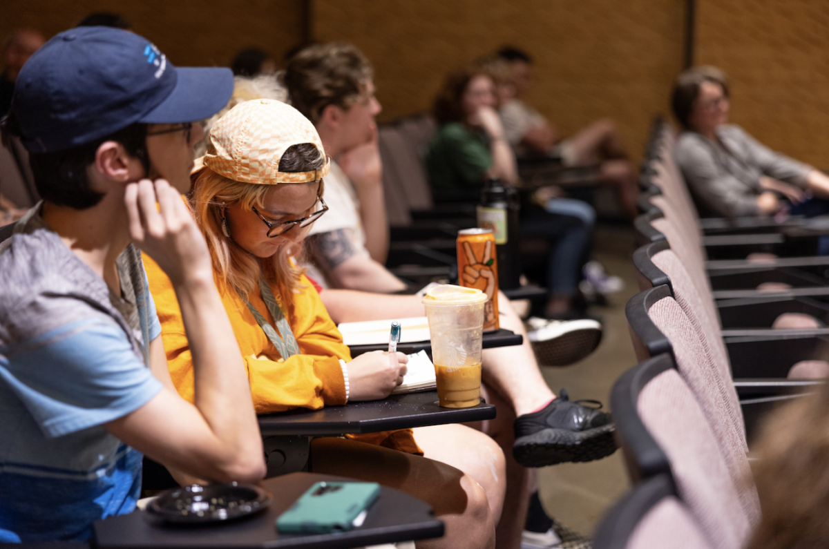 Students listen and take notes during a reading by author Joe Milan Jr. hosted at Austin Peay State University. | Photo by Sean McCully
